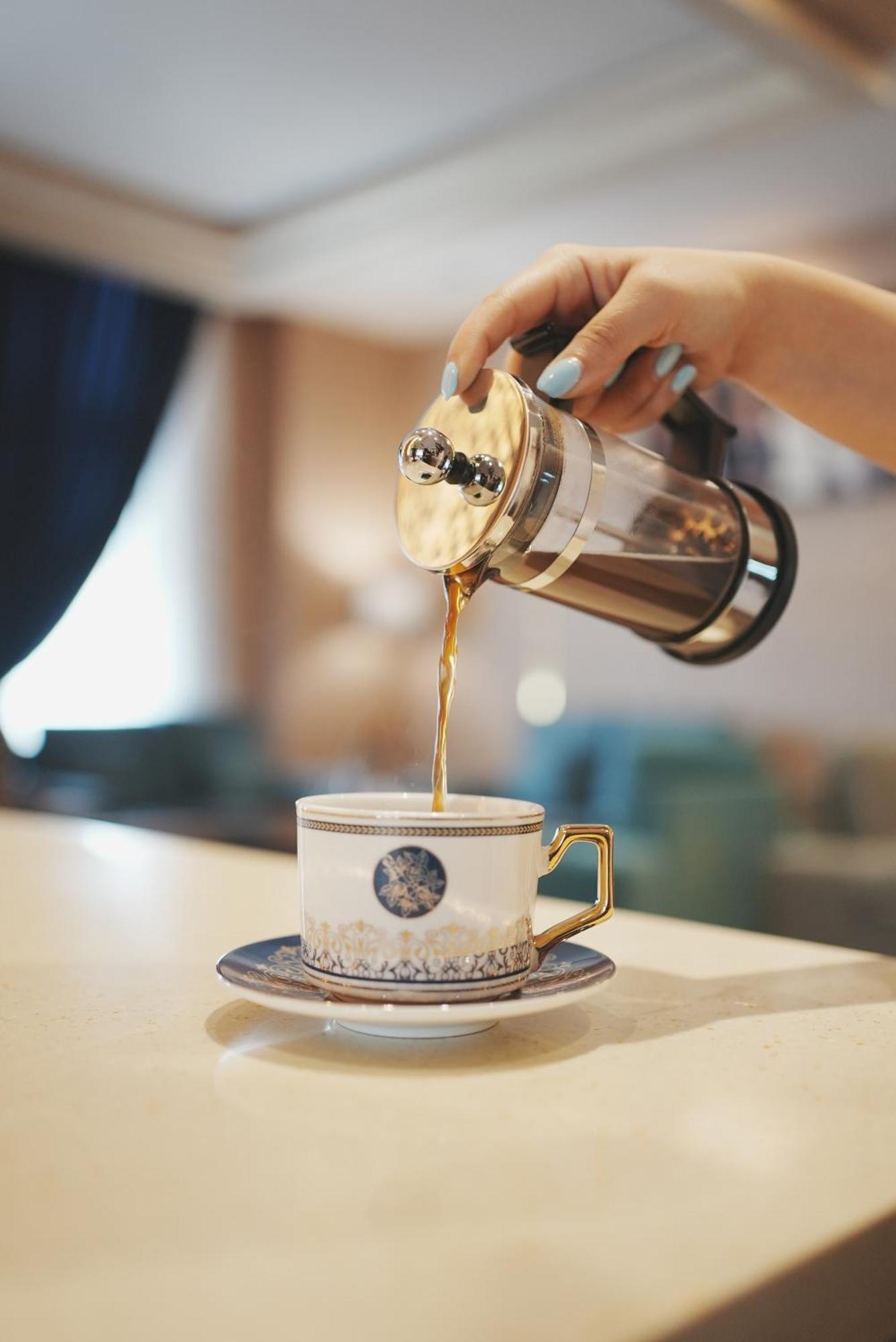 Thousand Nights Hotel Amman Exterior photo Coffee being poured from a French press