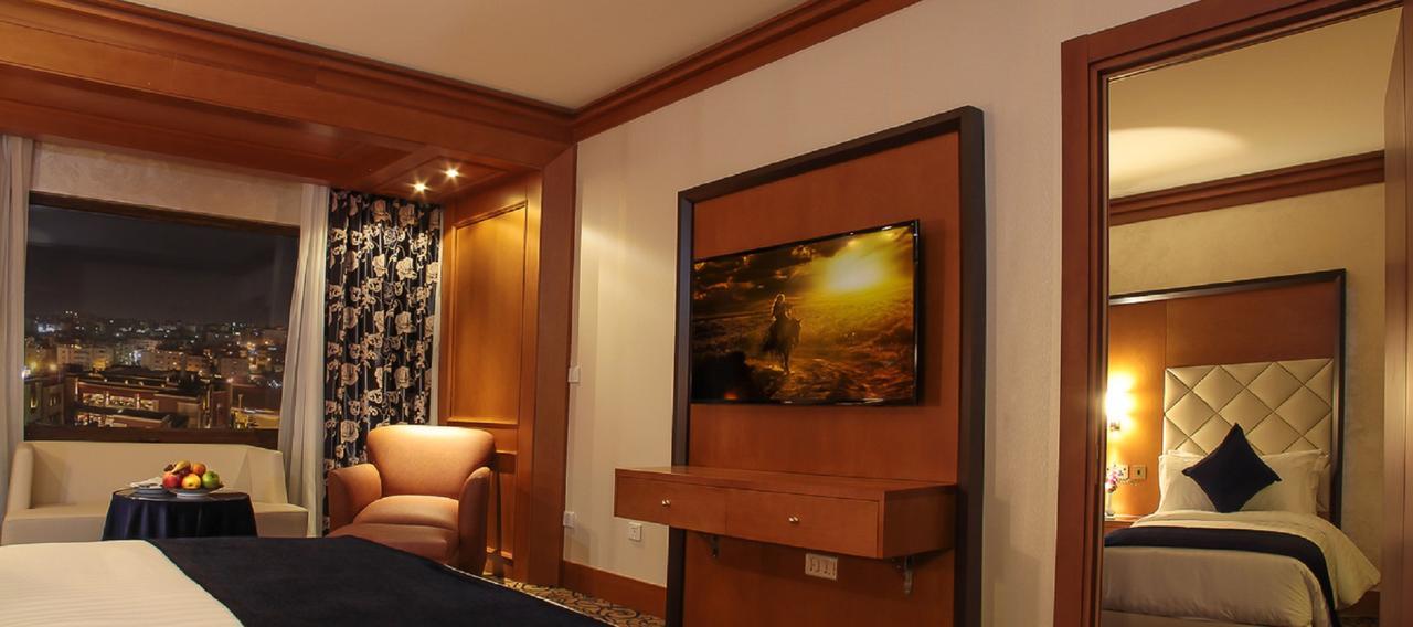 Thousand Nights Hotel Amman Exterior photo A television in a hotel room